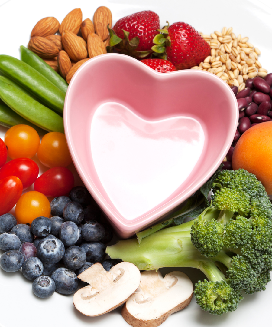 Veggie, fruit, and nut platter with a heart shaped dish in the middle 